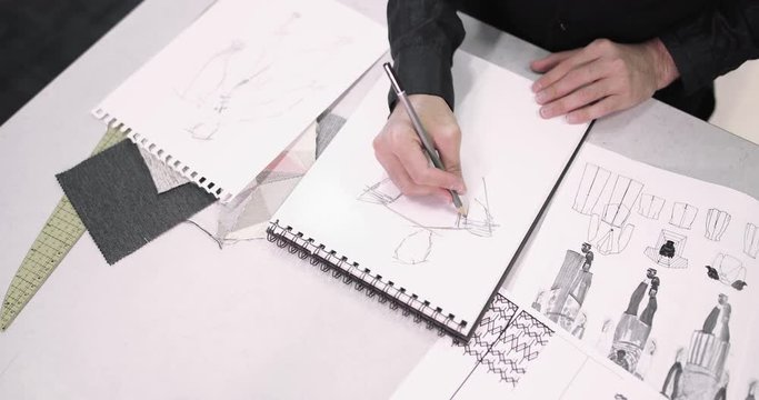 Overhead shot fashion designer sketching a design