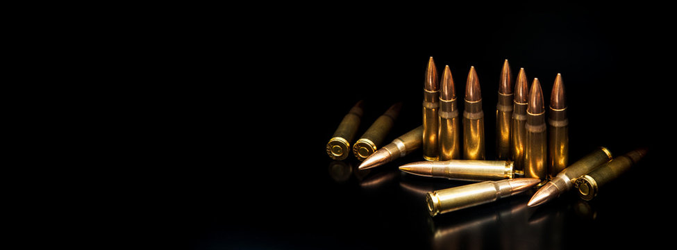 Bullet isolated on black background with reflexion. Rifle bullets close-up on black back. Cartridges for rifle and carbine on a black.