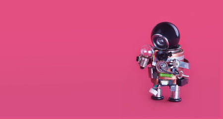 Machine learning and creative idea concept. Funny robotic toy holds light bulb. creative design...