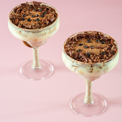 italian dessert tiramisu in an elegant cocktail glass, the concept of sweet life, luxury, delicious food