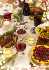 christmas dinner and eating concept - food and drinks on table at home