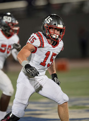 Young Athletic Teen Boy Playing in an American Football Game