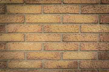 A wall full of orange and brown bricks