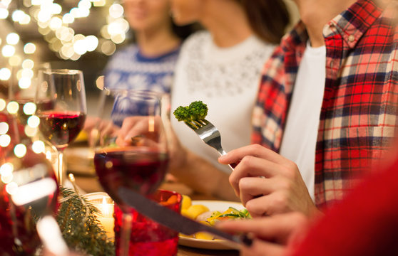 holidays, healthy food and celebration concept - close up of friends having christmas dinner and eating
