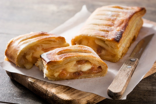 Traditional homemade apple strudel on wooden table