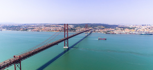 Lisbon, Portugal. Ponte 25 de Abril Suspension Bridge with Lisbon in background. Connects the...