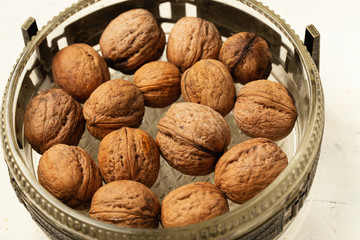 Walnuts on vintage bowl, healthy food