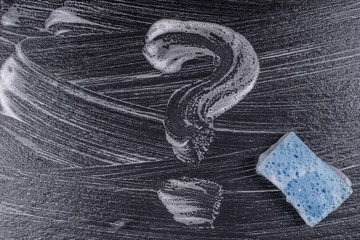 Question mark made from soap foam on a black background. Abstract foam texture on black background. Soap foam bubbles abstract dark background