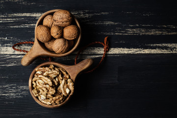 Walnuts brain and nuts whole in wooden caps. Space for copy