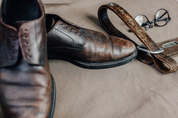 Brown leather retro shoes with strap glasses and a pocket watch. Vintage style.