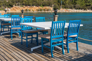 Table and chairs in beach cafe near sea water, Bodrum, Turkey. Beach cafe near sea, outdoors