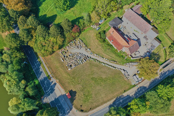 Vertical aerial view of a former farm, which is used as a warehouse for building materials.