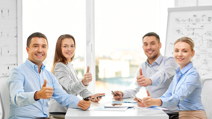 business people, gesture and success concept - happy smiling creative team showing thumbs up at office