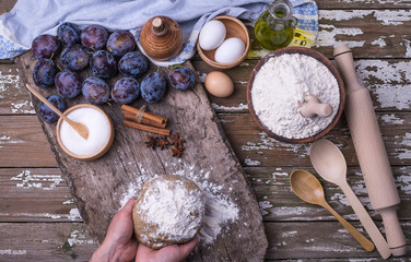 Women's hands hold fresh dough from natural ingredients.