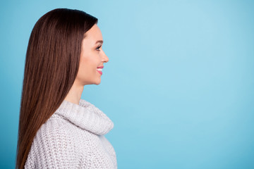 Fototapeta premium Profile side of funky cute sweet girl look listen have free time with her friends wear trend jumper isolated over blue color background