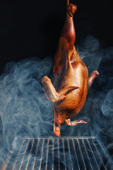 Slow smoking of whole chicken in the smokehouse - stationary grill