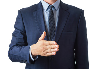 Young man in a blue suit holds out his palm for a handshake, on a white background