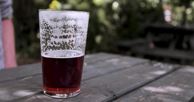 Close up drinking half full pint real ale beer