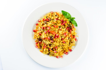 Uzbek pilaf with pomegranate on a white plate