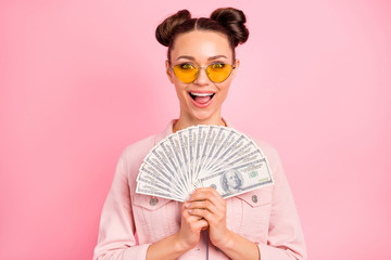 Close-up portrait of her she nice-looking attractive lovely winsome cheerful cheery delighted girl holding in hands large sum win winner isolated on pink pastel background