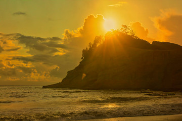 sunset over the last hill on the coast