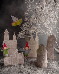 Christmas Advent calendar, paper houses, snow, elf figures. Christmas miniature decoration for a children's room. Little Christmas Village