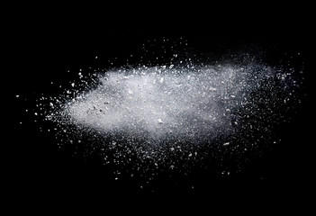 Freeze motion of white color powder exploding on dark background. 