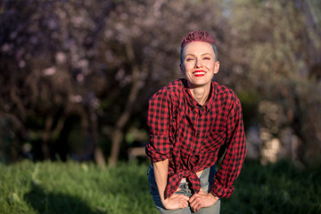 Portrait of a modern girl with bright pink and blue short hairstyle. Outdoors casual portrait. Hair coloring