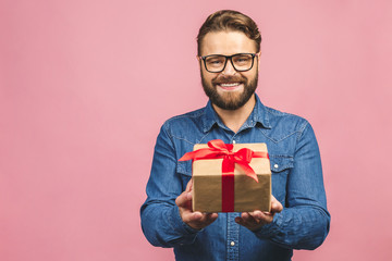 Happy holiday, my congredulations! Portrait of an attractive casual man giving present box and...