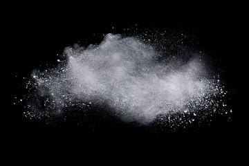 Freeze motion of white color powder exploding on dark background. 