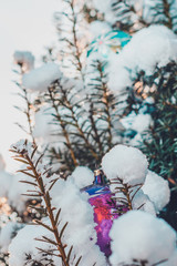 A real Christmas tree in the Ukrainian village of western Ukraine smothered by snow on the street and decorated with colorful balls