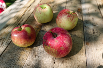 Red apples in basket on grey wooden background