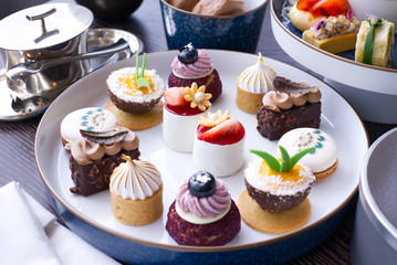 The afternoon tea with sweet desserts on table in the restaurant
