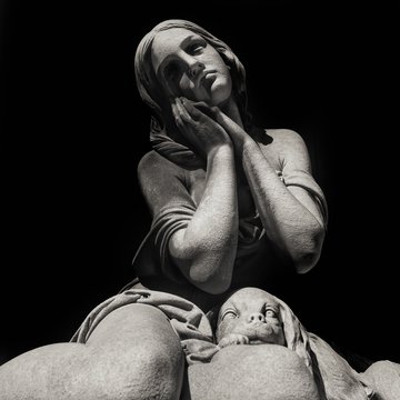 Young beautiful girl praying with her dog