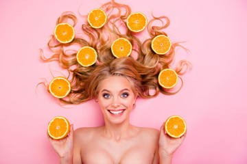 Obraz na płótnie Canvas Close up top above high angle view photo beautiful funny funky she her lady lying down among fruits long curly wavy hair cheer smiling oranges arms yummy tasty useful isolated pink background