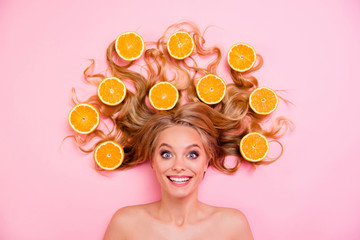 Obraz na płótnie Canvas Close up top above high angle view photo beautiful funny funky she her lady lying down oranges long curly wavy hair spring summer lifestyle cheerful pretty cool wash result isolated pink background