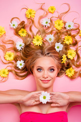 Vertical side profile top above high angle view photo beautiful cheer she her lady lying down among flowers long curly wavy hair one arm floral concept skin treatment enjoy isolated pink background