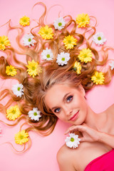 Obraz na płótnie Canvas Vertical top above high angle view photo beautiful she her lady lying down among flowers long curly wavy hair one arms floral concept skin treatment overjoyed summer mood isolated pink background