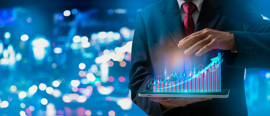 Businessman pointing arrow graph corporate future growth plan,hand with stock financial chart...