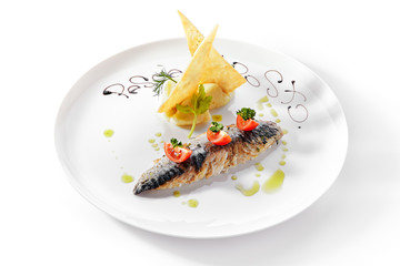Exquisite serving grilled mackerel with mashed potatoes and tomatoes