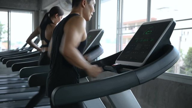 Sports concept. Men and women are running together at the fitness center.