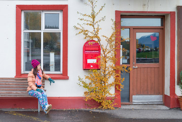 Women tourist looking the red old mailbox in Iceland. - 290109974