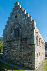 Haakon's Hall and blue sky in Bergenhus Fortress in Bergen, Norway. Haakon's Hall is a medieval stone hall located inside the Bergenhus fortress. This Hall is the largest - 290110166
