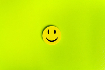 Positive Funny smiley face on a green cardboard background. Copy space for advertising and texts