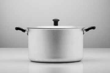 kitchen aluminum pan on light background with reflection