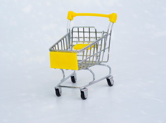 shopping cart with yellow handles on a white background