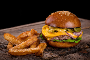 cheeseburger with fries on a wooden board