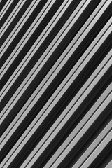 Obraz premium Vertical diagonal view of gray corrugated metal building facade.