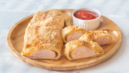 Sausage rolls with tomato sauce