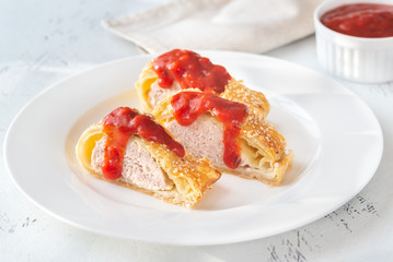 Sausage rolls with tomato sauce